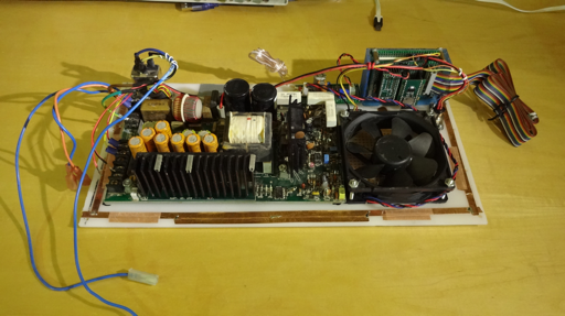 Guts of computer showing power supply, fan and Teensy assembly