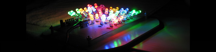 A beautiful array of colored LEDs aimed in all directions on a dark, reflective background